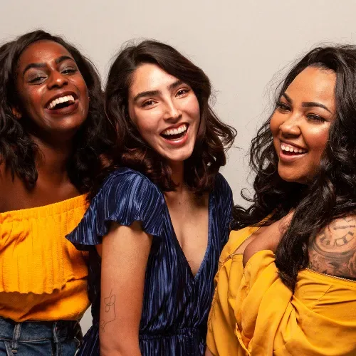 Three women laughing together